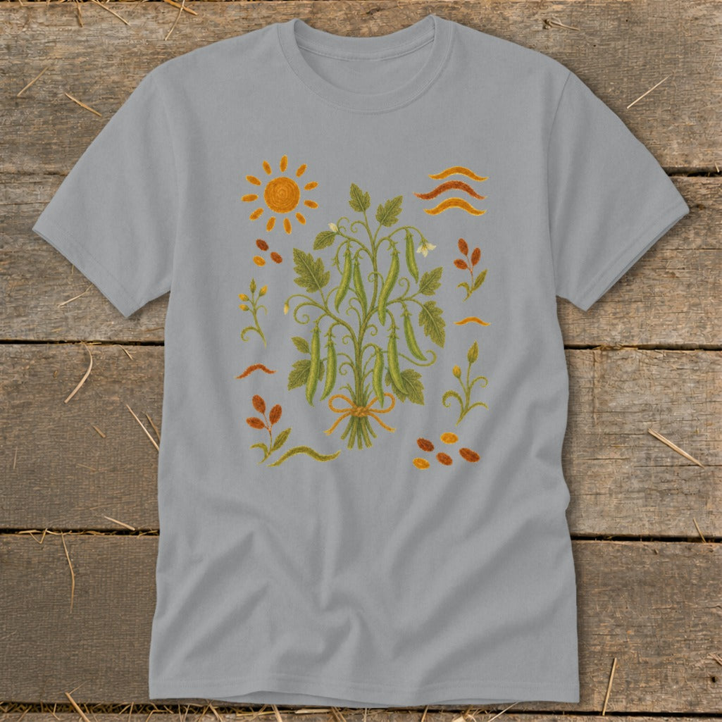 Grey t-shirt with a botanical illustration of a pea vine, sun, and scattered leaves.