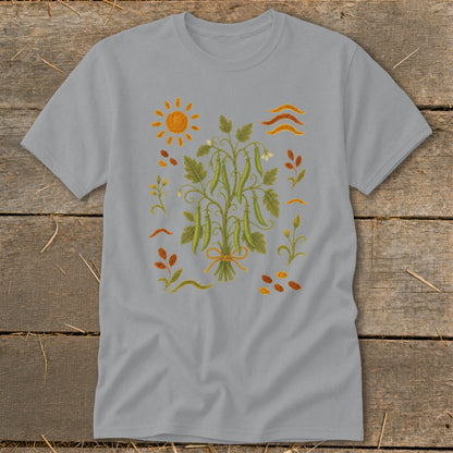 Grey t-shirt with a botanical illustration of a pea vine, sun, and scattered leaves.