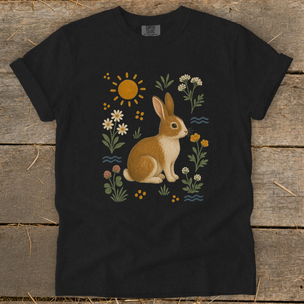 Black t-shirt with a rabbit and flowers illustration, sun and blue wavy lines.