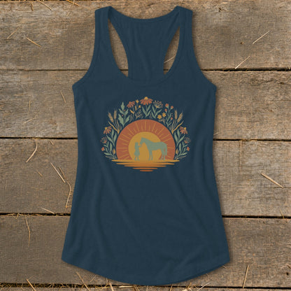 Navy tank top with girl and horse silhouette against a sunset and floral design.