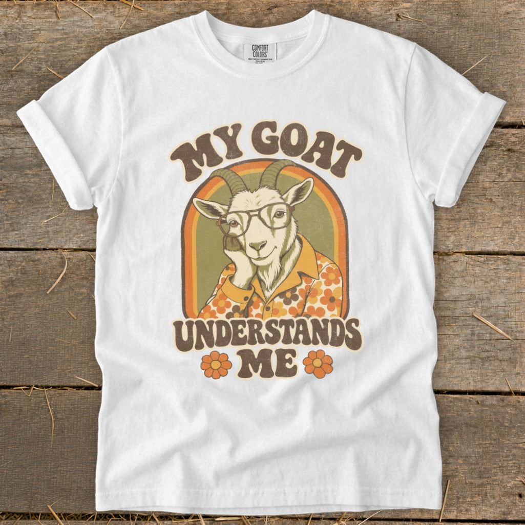 White t-shirt with "MY GOAT UNDERSTANDS ME" text and illustrated goat.