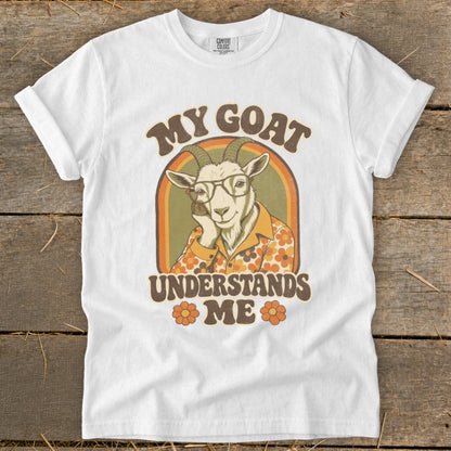 White t-shirt with "MY GOAT UNDERSTANDS ME" text and illustrated goat.