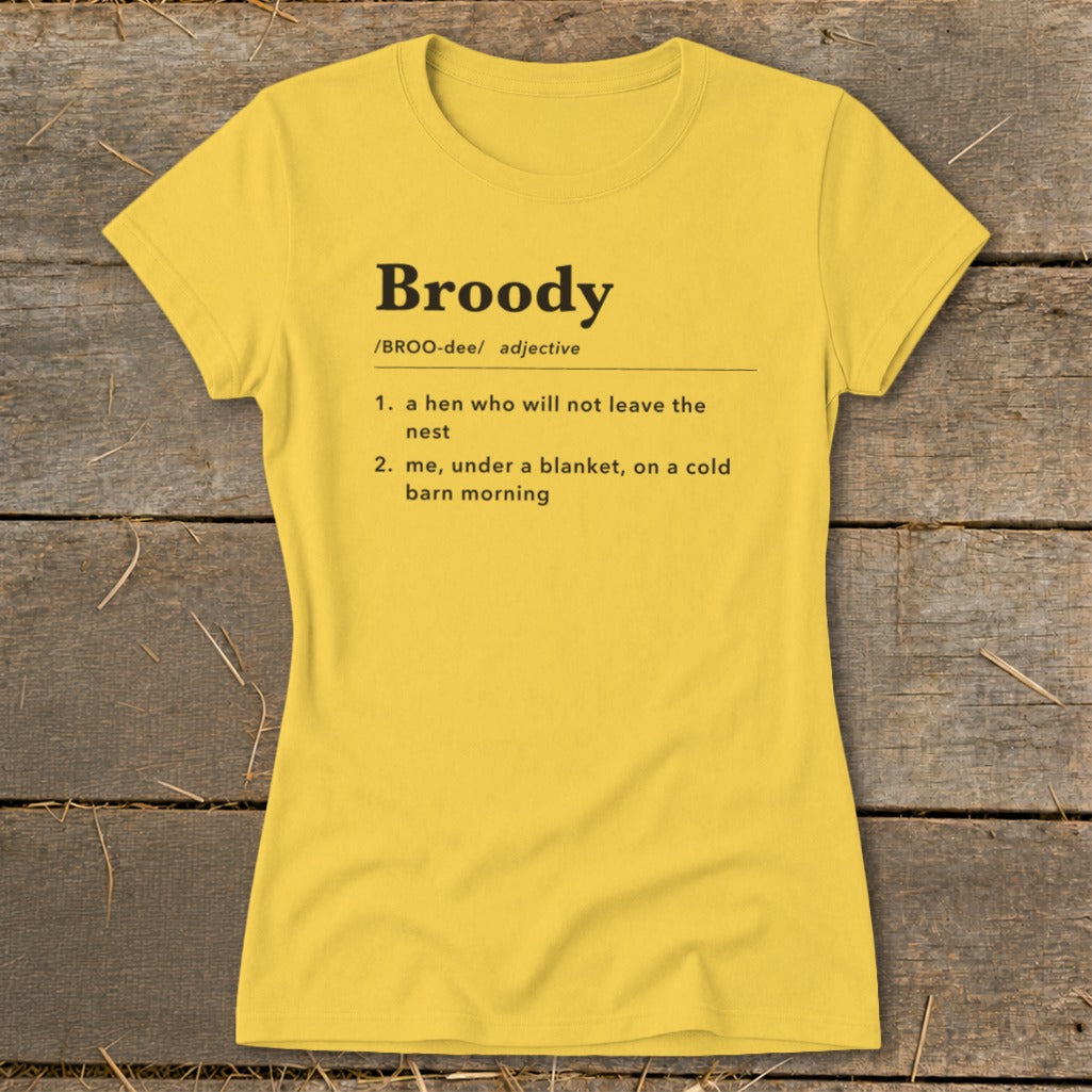 Yellow t-shirt with "Broody" definition: a hen not leaving nest, or me under a blanket.