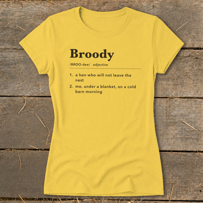 Yellow t-shirt with "Broody" definition: a hen not leaving nest, or me under a blanket.