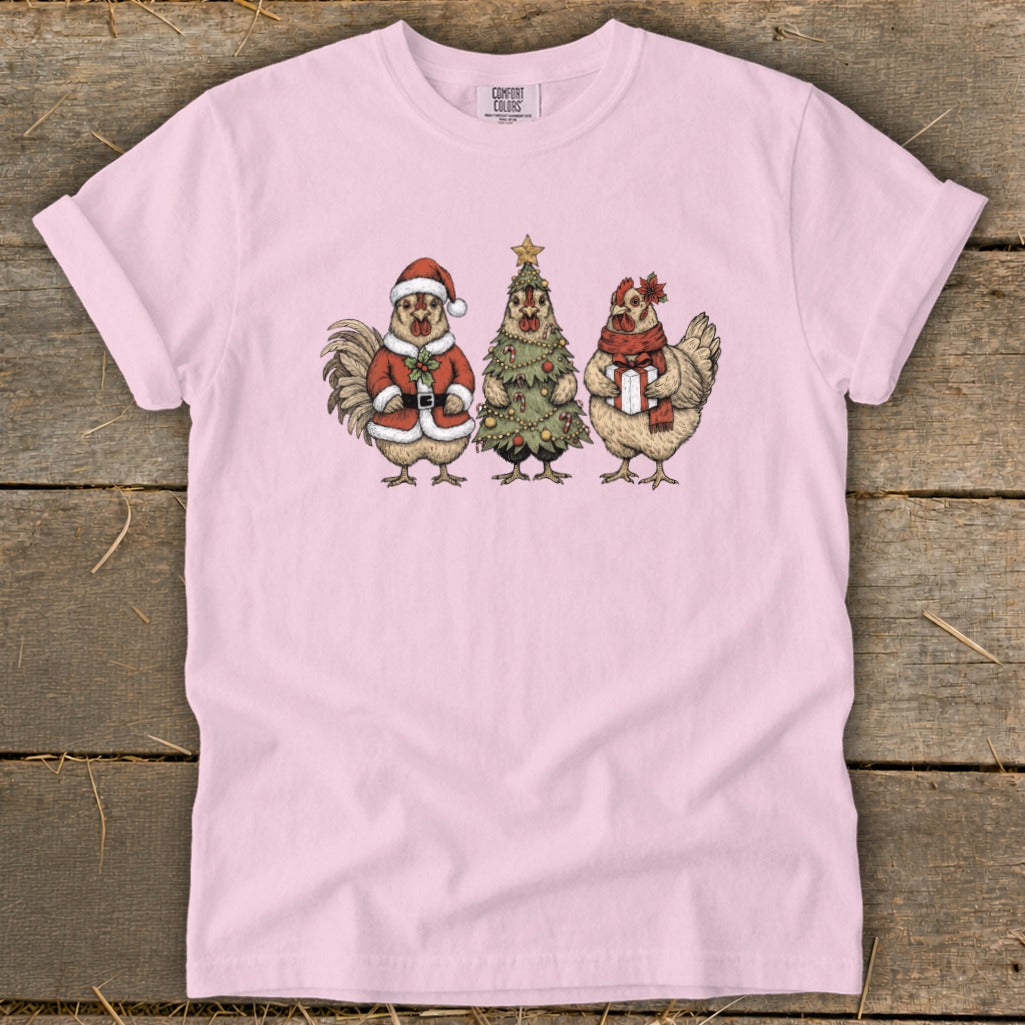 Rooster in Santa suit, chicken Christmas tree, and chicken with gift on pink shirt.