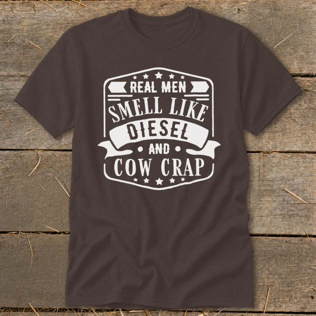 Brown t-shirt with white text "Real Men Smell Like Diesel And Cow Crap".