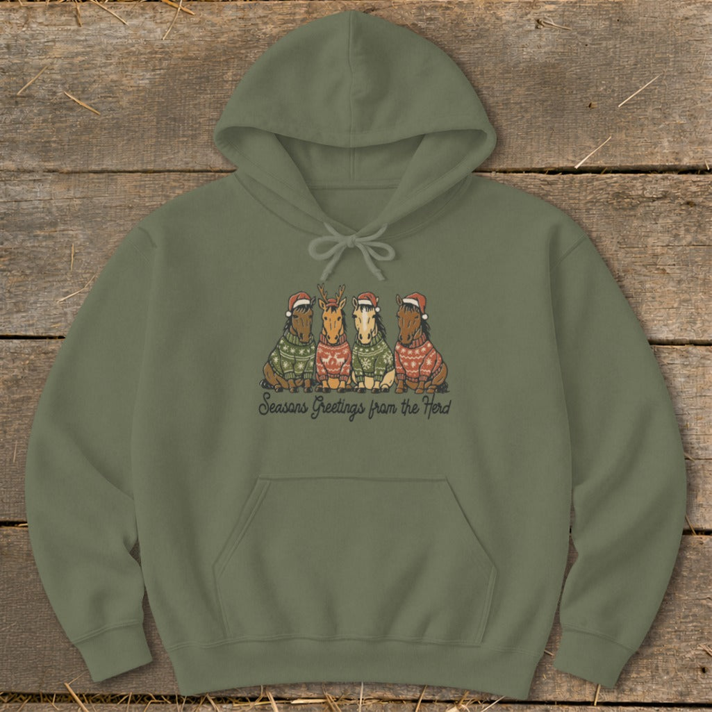 Olive green hoodie with four horses in Christmas sweaters and hats, saying "Seasons Greetings from the Herd."
