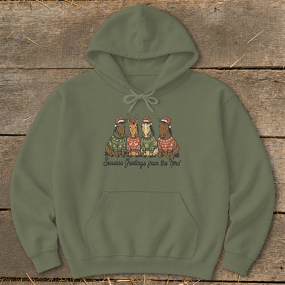 Olive green hoodie with four horses in Christmas sweaters and hats, saying "Seasons Greetings from the Herd."