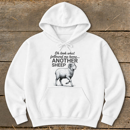 White hoodie with sheep graphic and text "Oh look what followed me home... ANOTHER SHEEP".