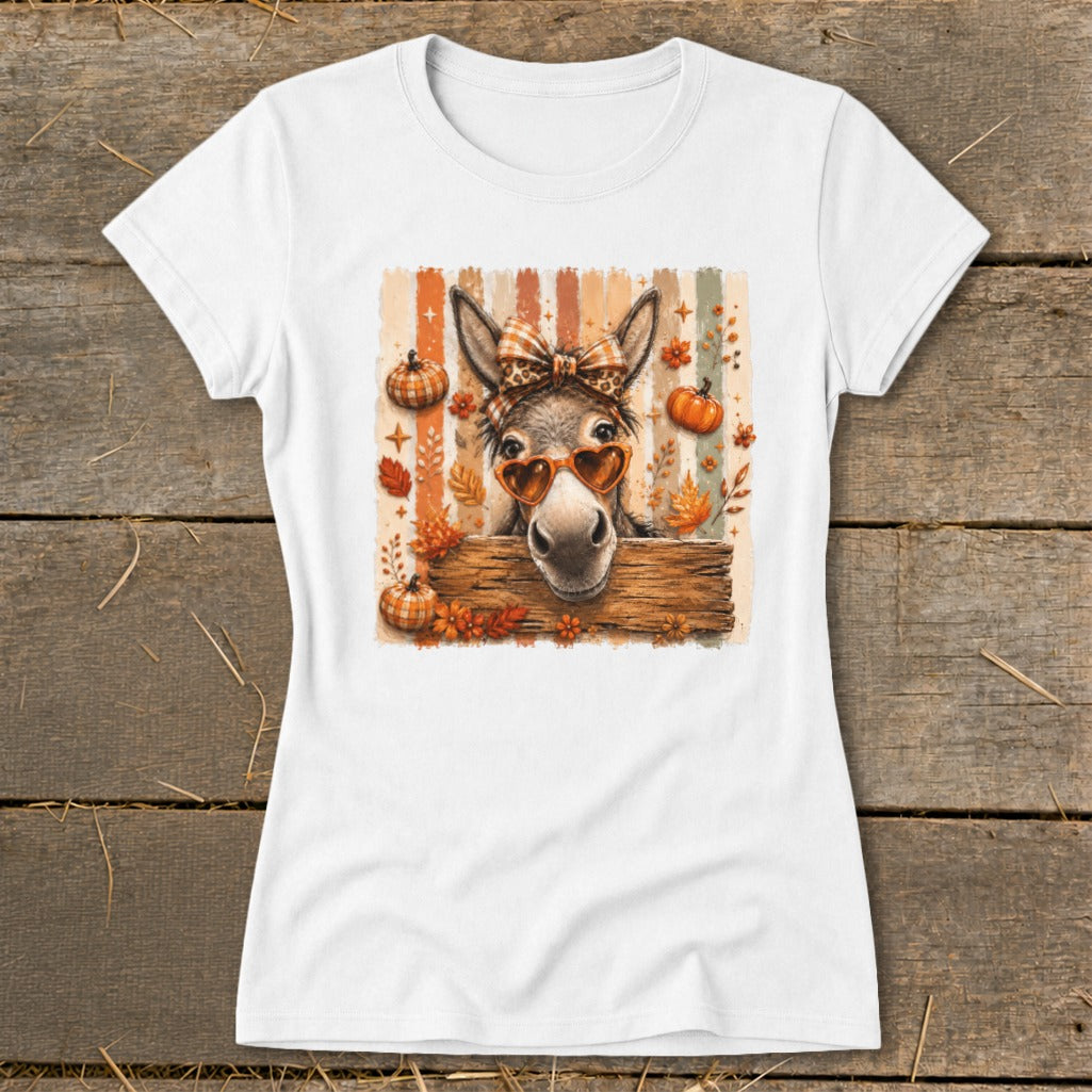 Donkey wearing heart sunglasses and bow, with pumpkins and leaves.