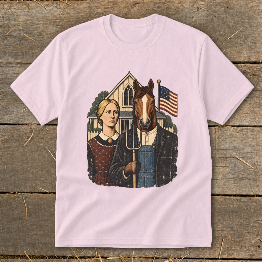 Light pink short-sleeved t-shirt featuring a vintage American Gothic parody design with a horse-headed farmer and a woman holding a pitchfork.