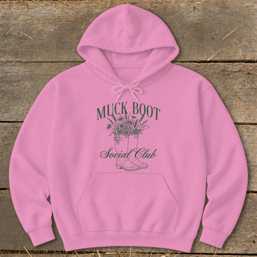 Pink hoodie with "Muck Boot Social Club" text and a floral boot design.