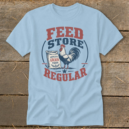 Light blue t-shirt with "Feed Store Regular" text and a rooster by a grain sack.