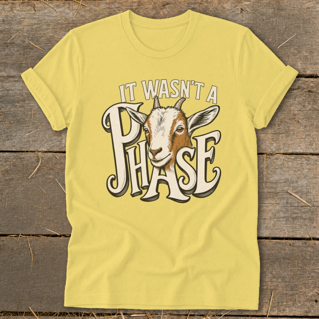 Yellow t-shirt with goat graphic and text "IT WASN'T A PHASE".