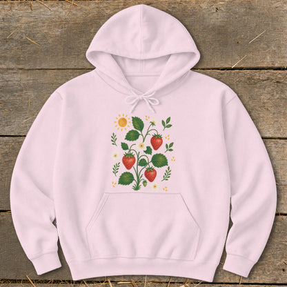 Pink hoodie with a strawberry plant graphic and a sun.