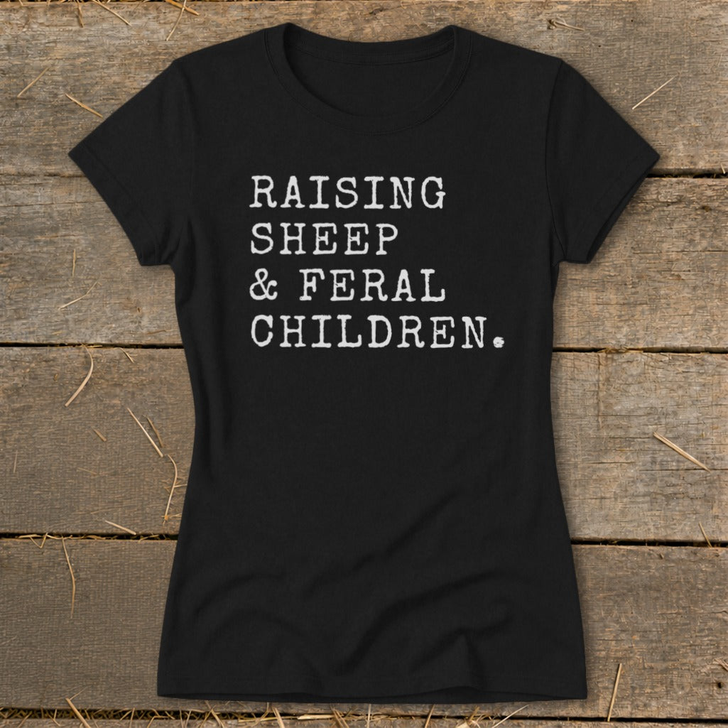 Black t-shirt with white text that reads "RAISING SHEEP & FERAL CHILDREN."