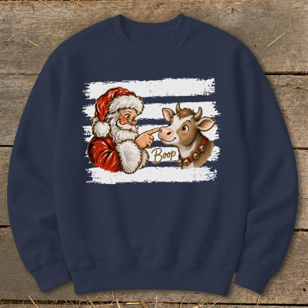 Santa boops a cow's nose with the word "Boop" printed.