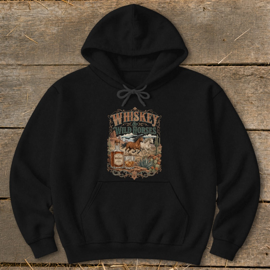 Black hoodie with "Whiskey & Wild Horses" graphic featuring horses, whiskey bottle, and desert landscape.