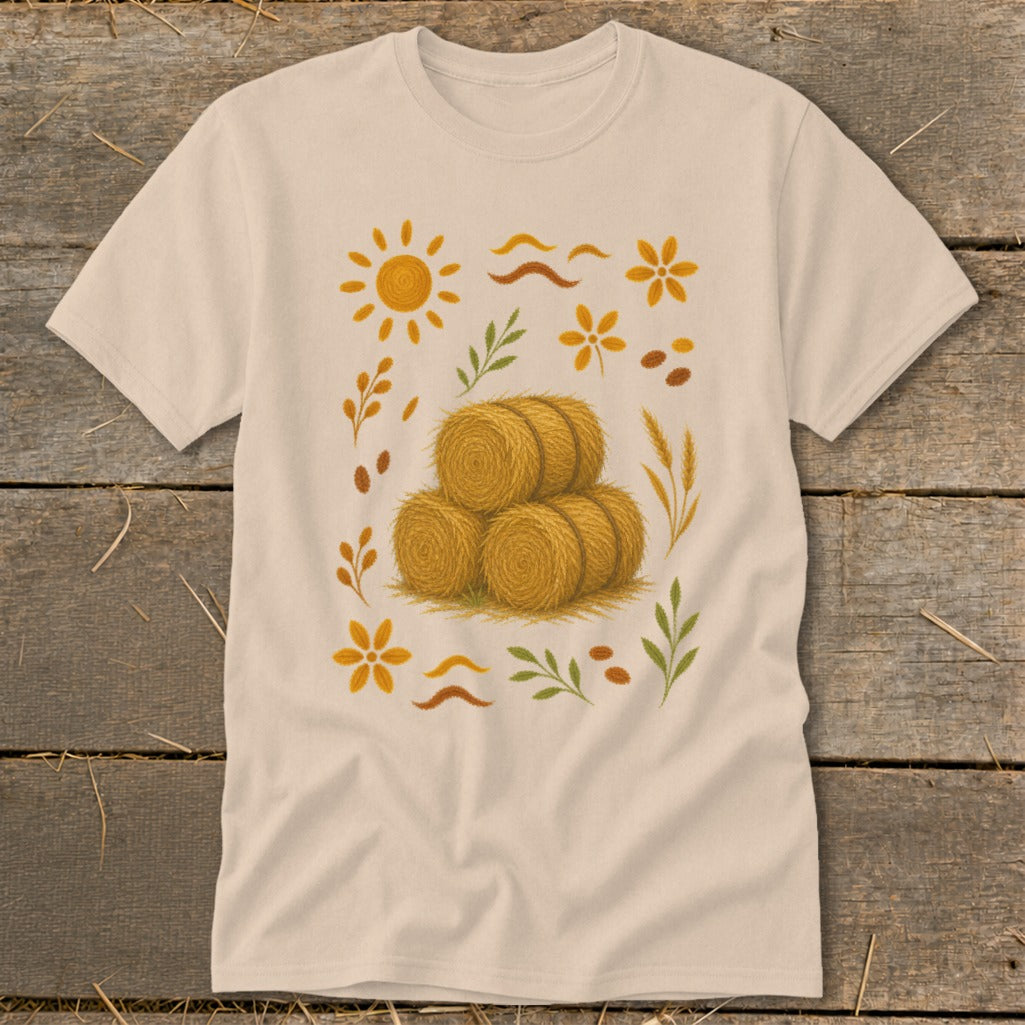 Light tan t-shirt with stacked hay bales and fall floral graphic design.
