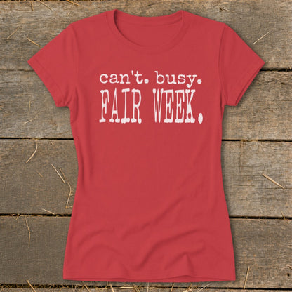 Red t-shirt with white text that reads "can't. busy. FAIR WEEK."