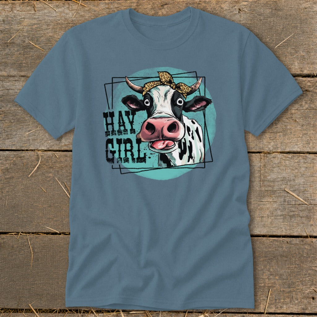 T-shirt with a black and white cow wearing a leopard print bandana and the text "HAY GIRL".