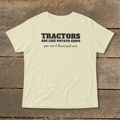 Light yellow t-shirt with black text: "Tractors are like potato chips, you can't have just one."