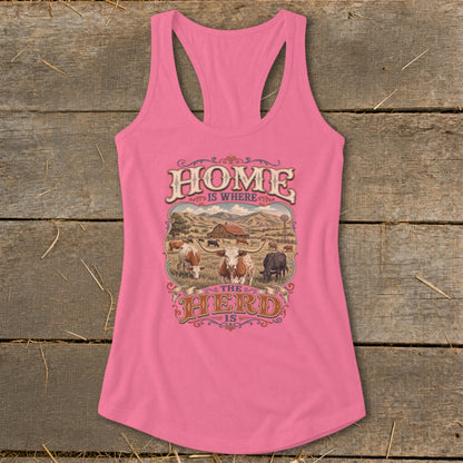 Pink tank top with "HOME IS WHERE THE HERD IS" graphic featuring cattle and a barn.