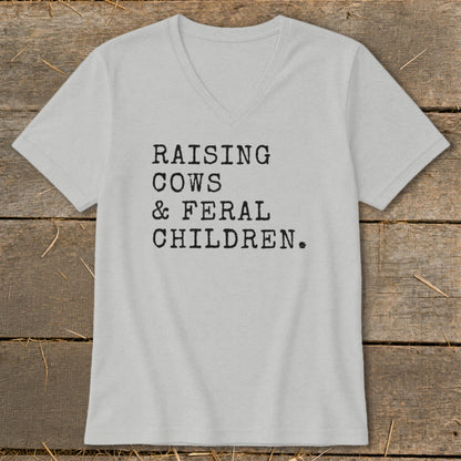 Light gray v-neck t-shirt with "Raising Cows & Feral Children." text.