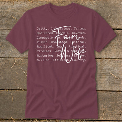 Maroon t-shirt with white text listing "Farm Wife" characteristics.