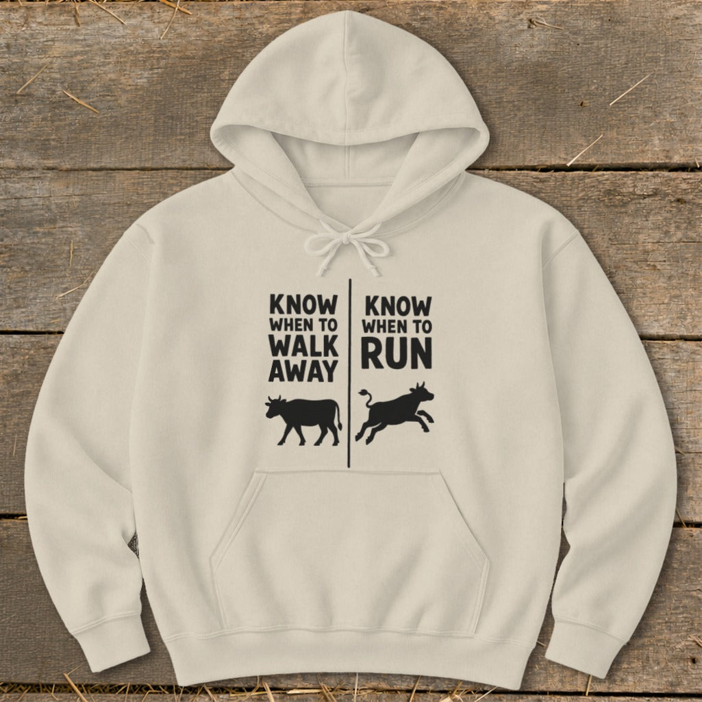 Beige hoodie with text "Know when to walk away" and "Know when to run" and cow graphics.