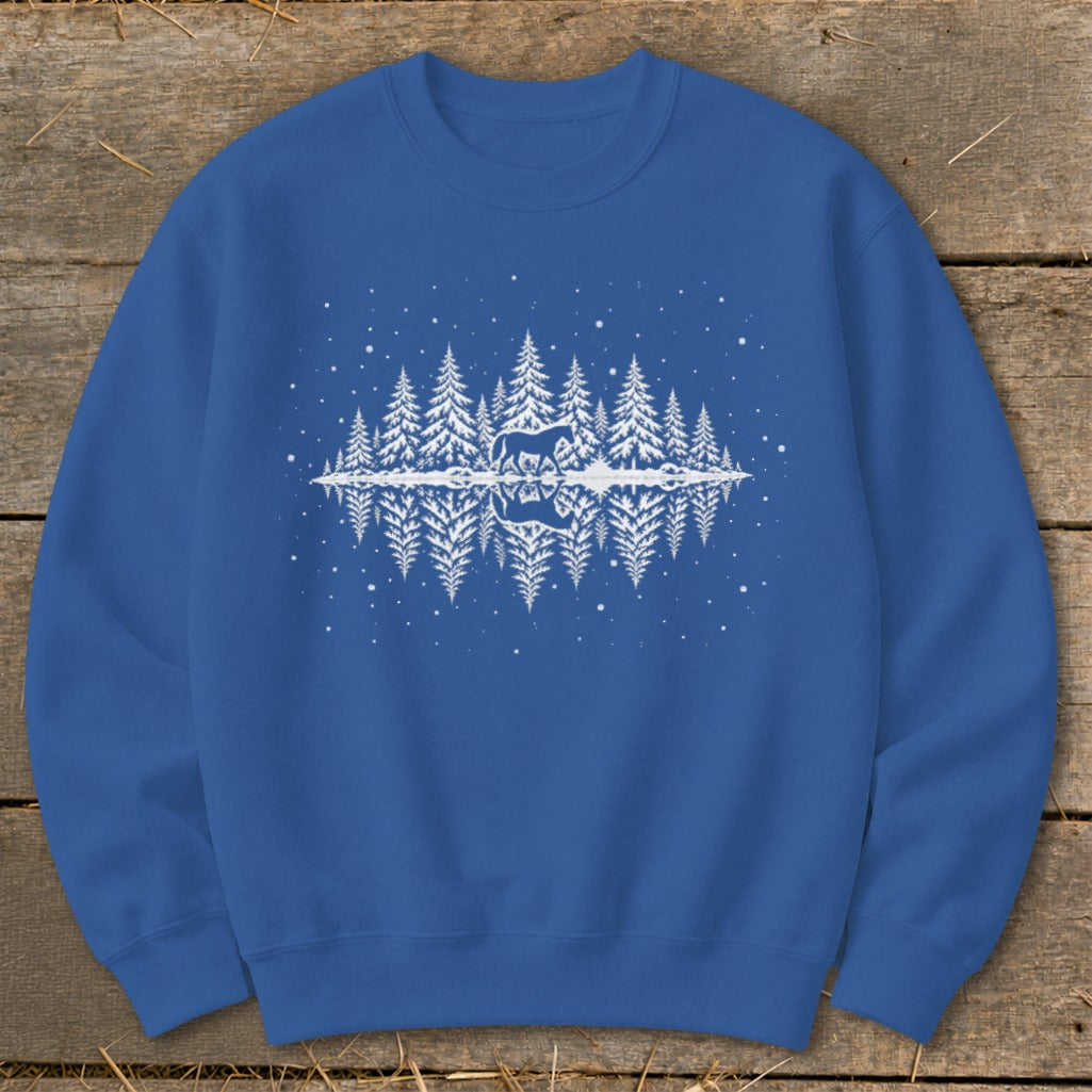 Blue sweatshirt with white graphic of a horse in a snowy forest reflected in water.