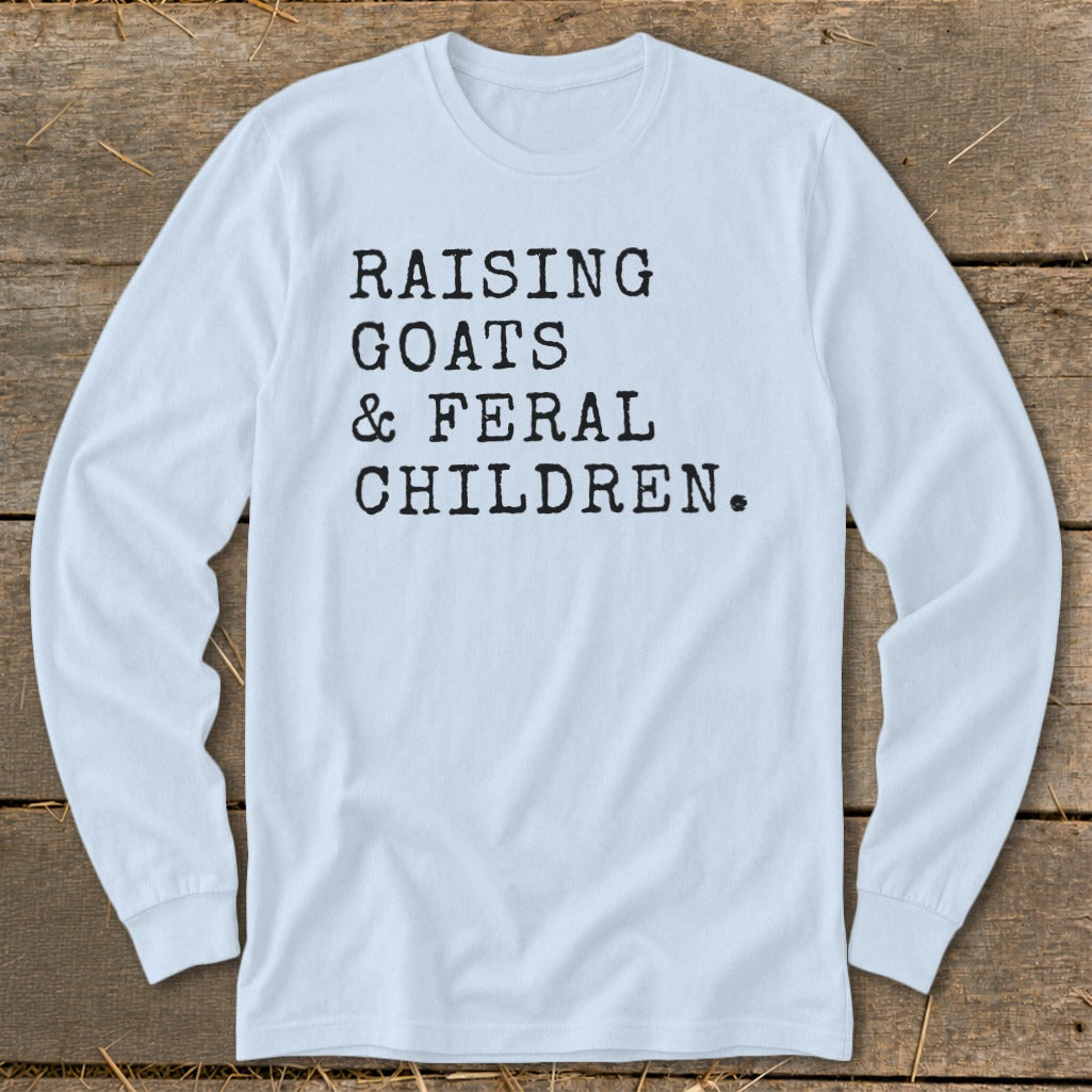 Light blue long-sleeved shirt with black text reading "RAISING GOATS & FERAL CHILDREN."