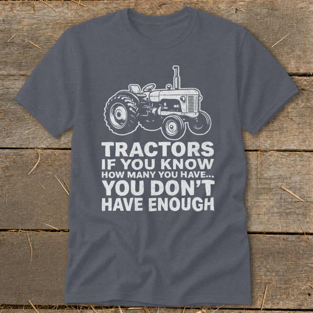 Gray t-shirt with a white graphic of a tractor and text that reads "TRACTORS IF YOU KNOW HOW MANY YOU HAVE... YOU DON'T HAVE ENOUGH".