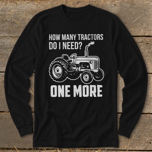 Black long-sleeve shirt with tractor graphic and text: "HOW MANY TRACTORS DO I NEED? ONE MORE"