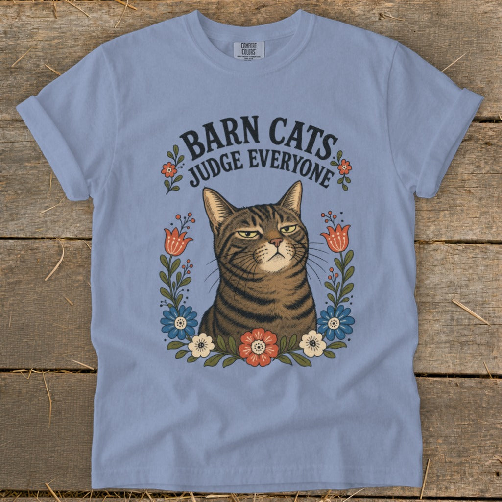 Light blue t-shirt with a tabby cat and the text "Barn Cats Judge Everyone".