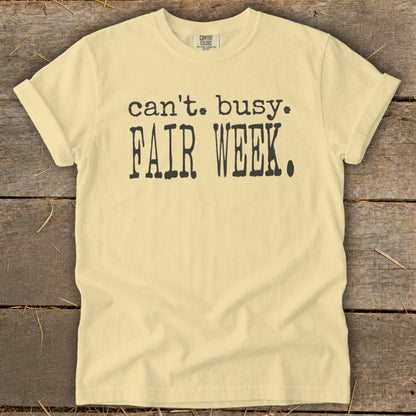 Light yellow t-shirt with black text that says "can't. busy. FAIR WEEK."