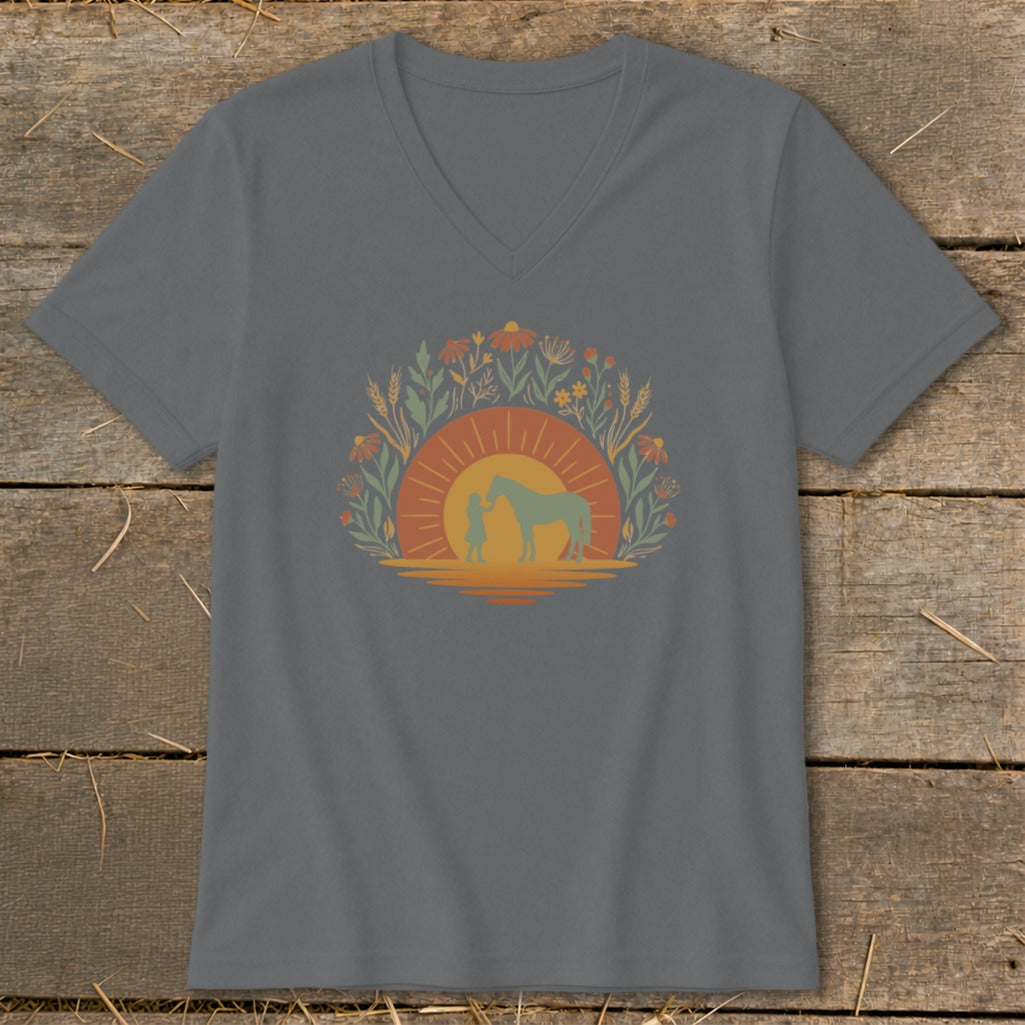Gray t-shirt with a graphic of a person and horse at sunset surrounded by wildflowers.