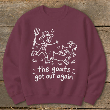 Maroon sweatshirt with white line art of a farmer chasing goats and text "the goats got out again".