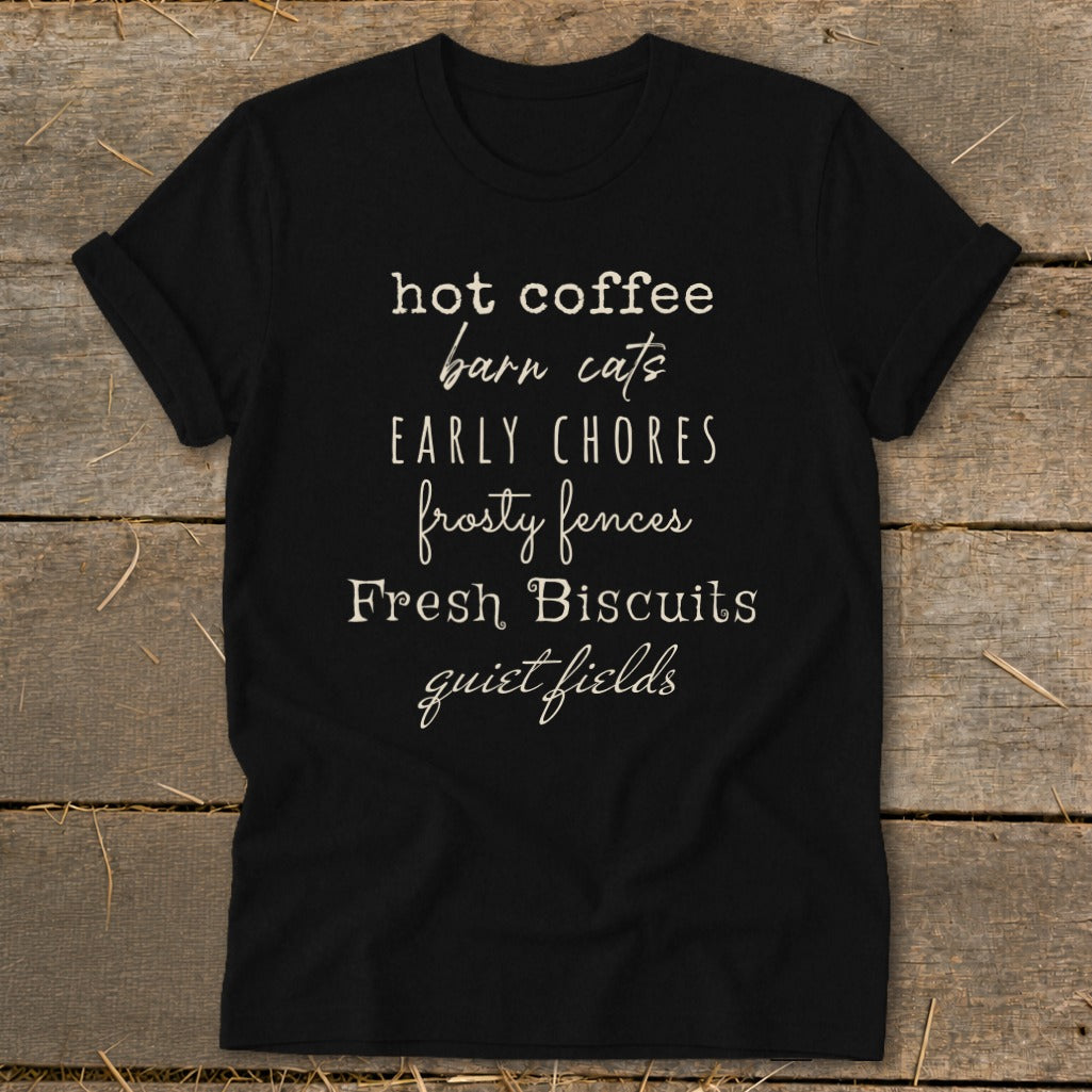 Black t-shirt with text "hot coffee barn cats early chores frosty fences Fresh Biscuits quiet fields".