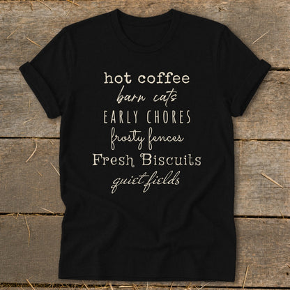 Black t-shirt with text "hot coffee barn cats early chores frosty fences Fresh Biscuits quiet fields".