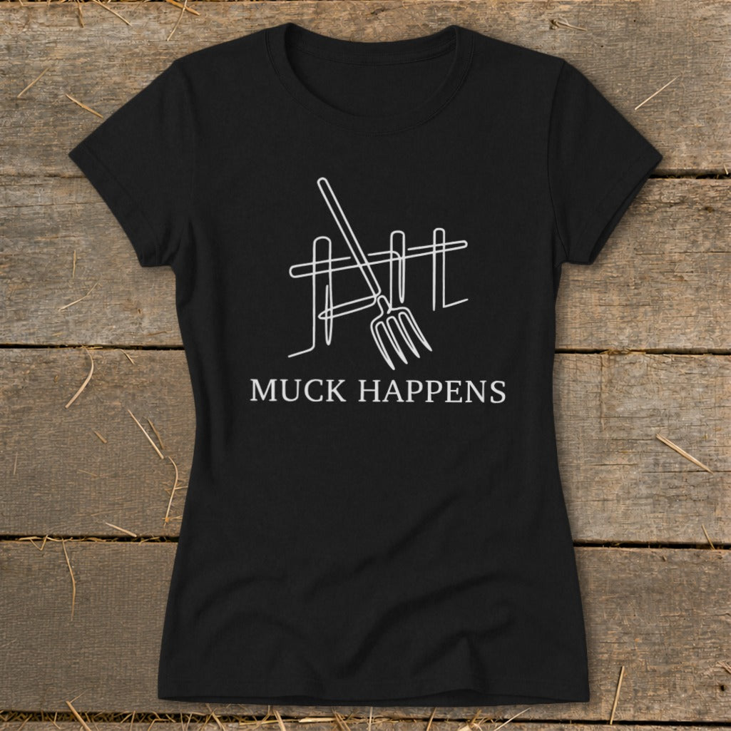 Black t-shirt with white outline of pitchfork and fence, text "MUCK HAPPENS".
