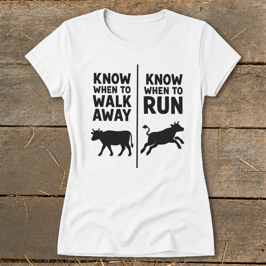 White t-shirt with text "KNOW WHEN TO WALK AWAY" and a walking cow, and "KNOW WHEN TO RUN" with a running cow.