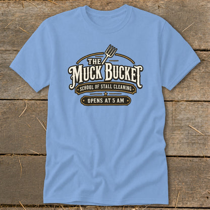 Light blue t-shirt with "The Muck Bucket School of Stall Cleaning Opens At 5 AM" graphic.