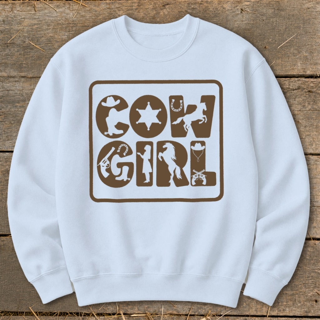 White sweatshirt with brown "Cowgirl" text and western graphic icons.