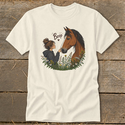 Girl booping horse nose surrounded by flowers, text "Boop" above.