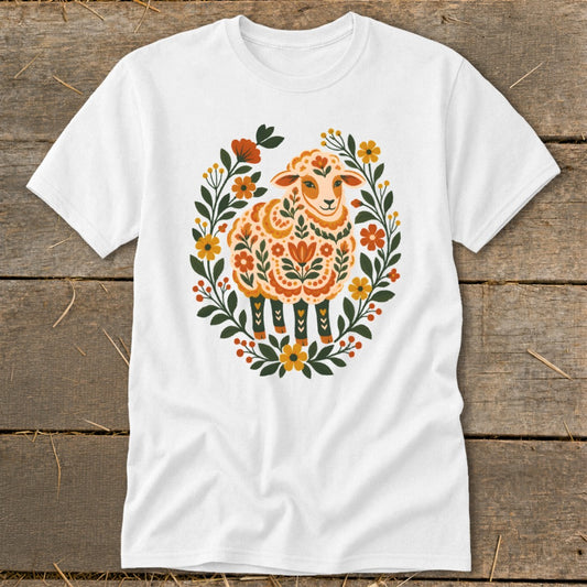 White t-shirt with a folk art sheep illustration surrounded by floral elements.