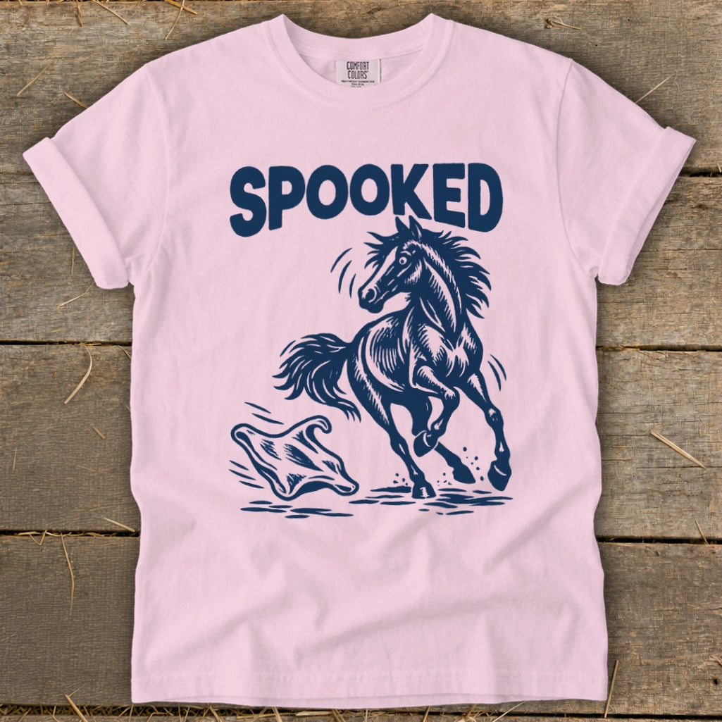 Pink t-shirt with navy blue graphic of a spooked horse running from a ghost.