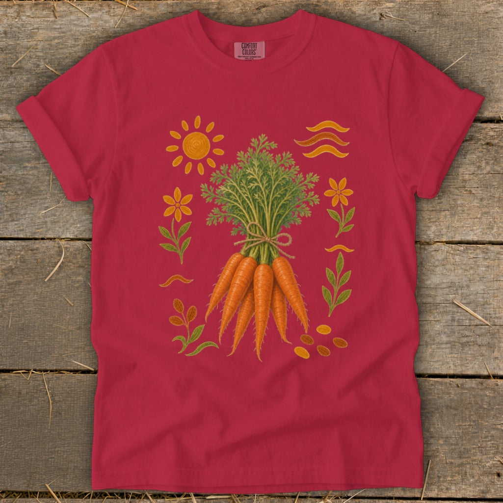 Crimson t-shirt with embroidered carrots, sun, flowers, and leaves design.
