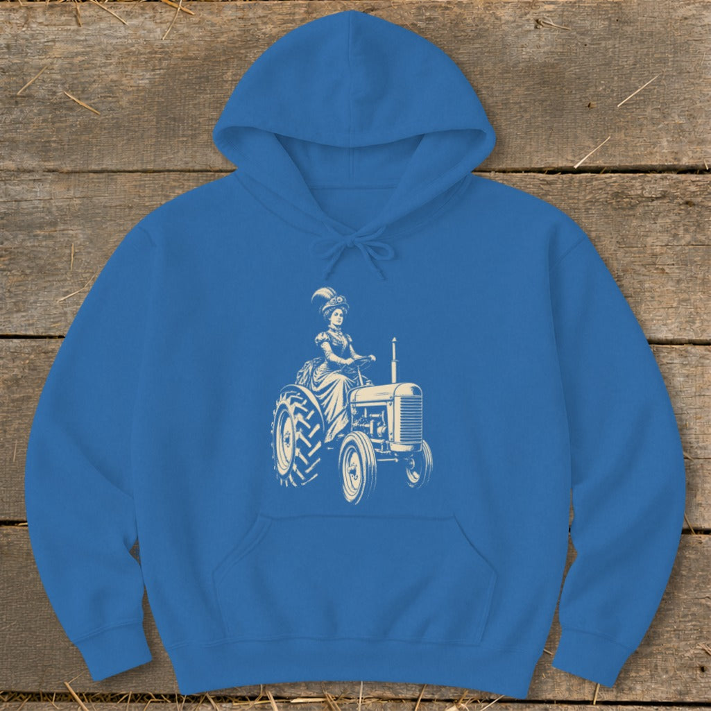 Blue hoodie with cream graphic of a woman in a historical dress driving a tractor.