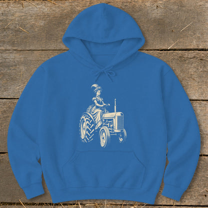 Blue hoodie with cream graphic of a woman in a historical dress driving a tractor.